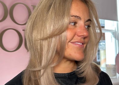 Woman with radiant blonde hair at The Doll House York, York, England, GB, showcasing salon expertise.