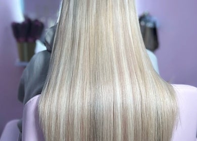 Sleek blonde hair at The Doll House York, York, England, GB, showcasing luxurious salon styling.