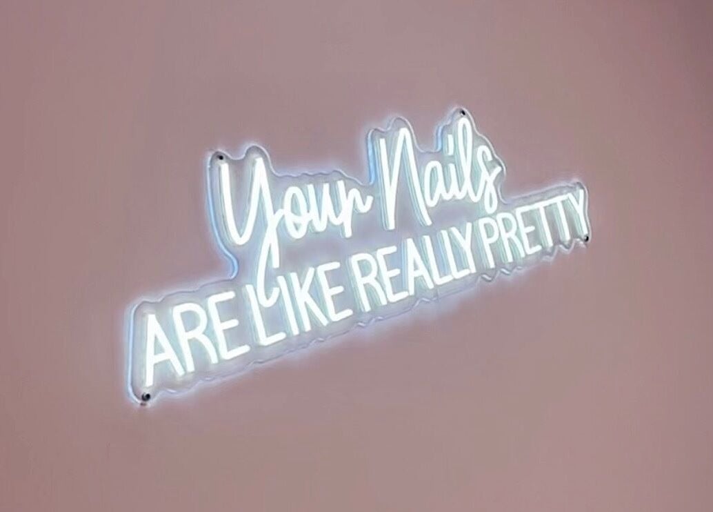 Neon sign reading 'Your Nails Are Like Really Pretty' at The Doll House York, York, England, GB.