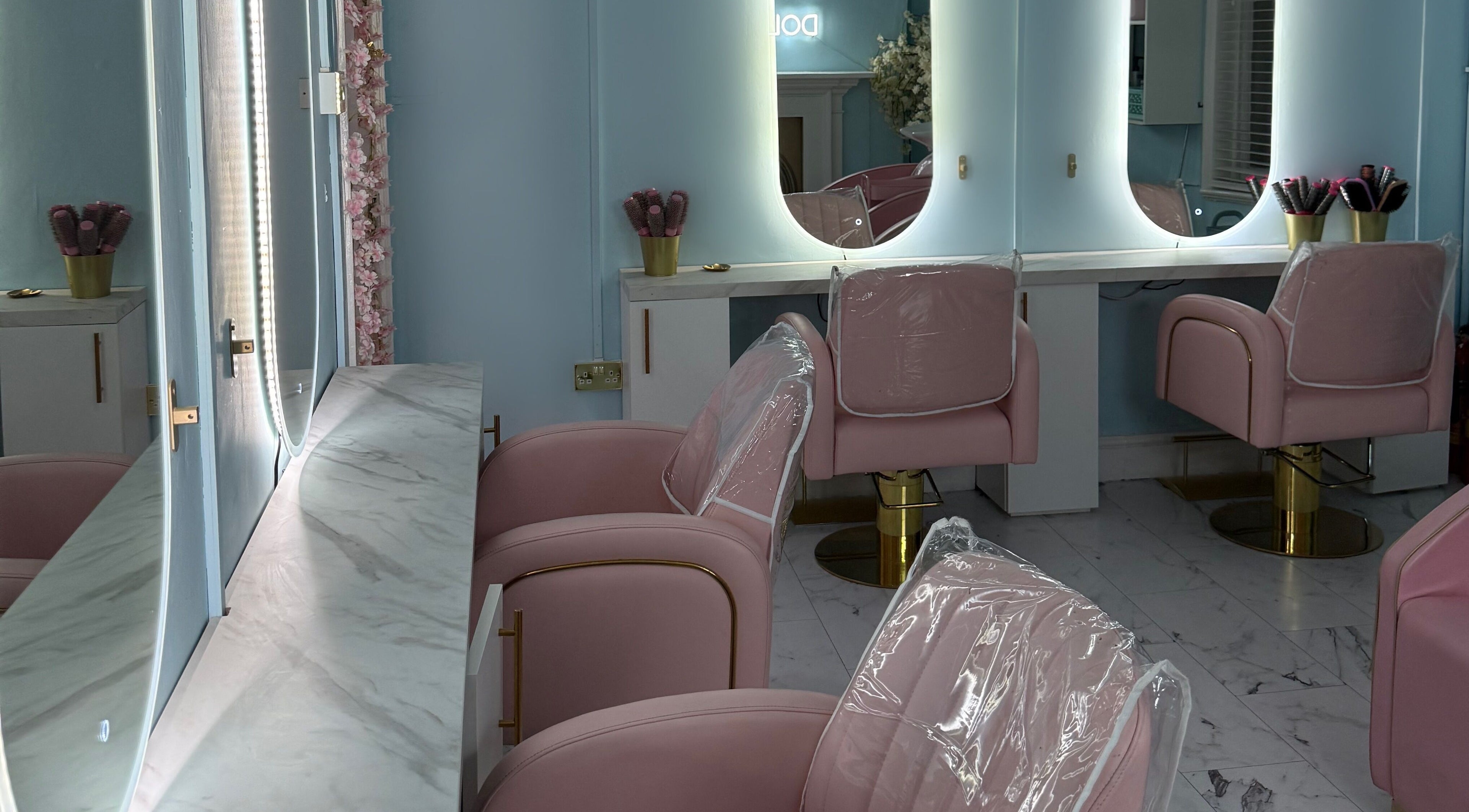 Elegant pink salon chairs in The Doll House York, York, England, GB, offering luxurious beauty treatments.