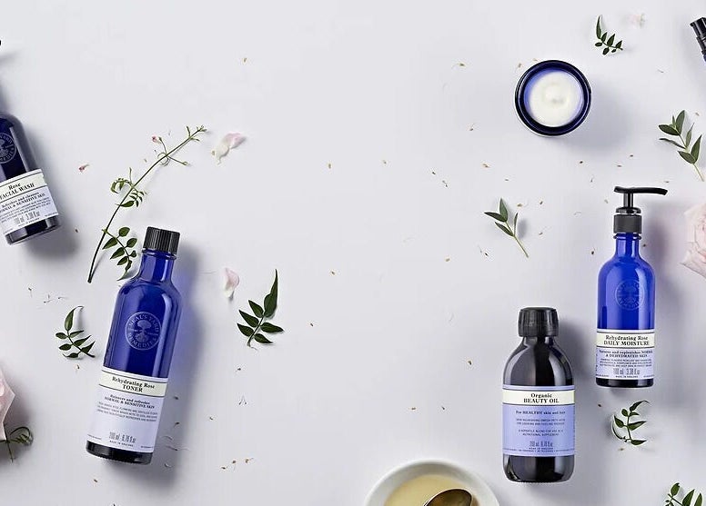 Elegant skincare products at Jasia Holistic@ The Vale Living, London, GB, surrounded by flowers and greenery.