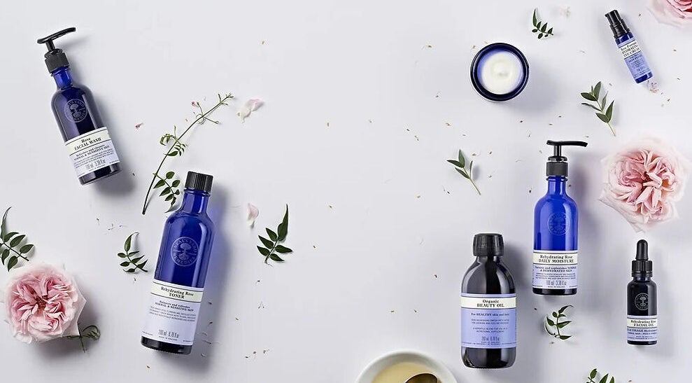 Elegant skincare products at Jasia Holistic@ The Vale Living, London, GB, surrounded by flowers and greenery.