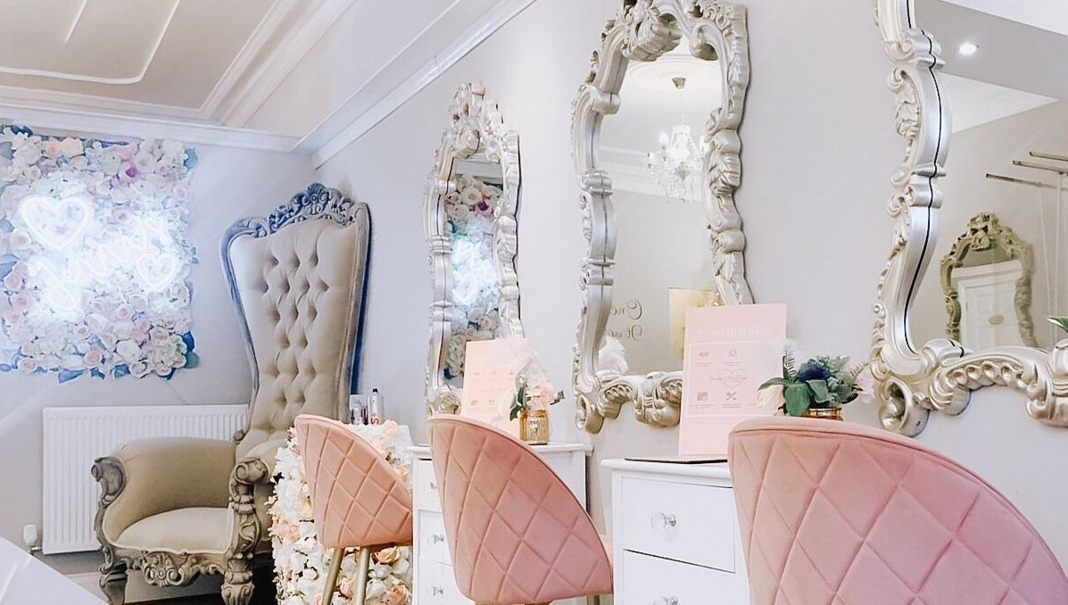 Elegant beauty salon interior at Jenna Mcdonnell, Newport, Wales, GB, featuring plush chairs and ornate mirrors.