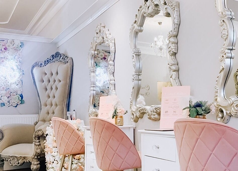 Elegant beauty salon interior at Jenna Mcdonnell, Newport, Wales, GB, featuring plush chairs and ornate mirrors.