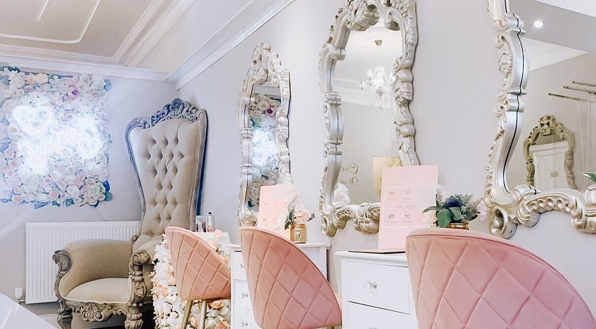 Elegant beauty salon interior at Jenna Mcdonnell, Newport, Wales, GB, featuring plush chairs and ornate mirrors.