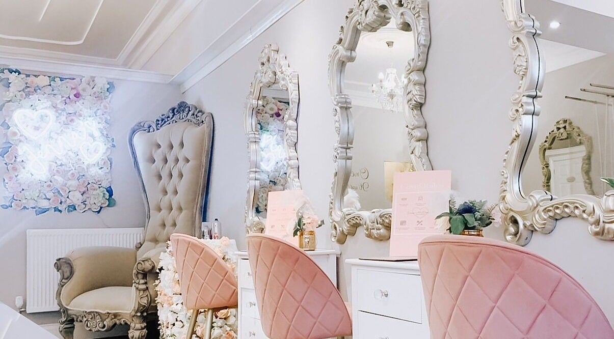 Elegant beauty salon interior at Jenna Mcdonnell, Newport, Wales, GB, featuring plush chairs and ornate mirrors.