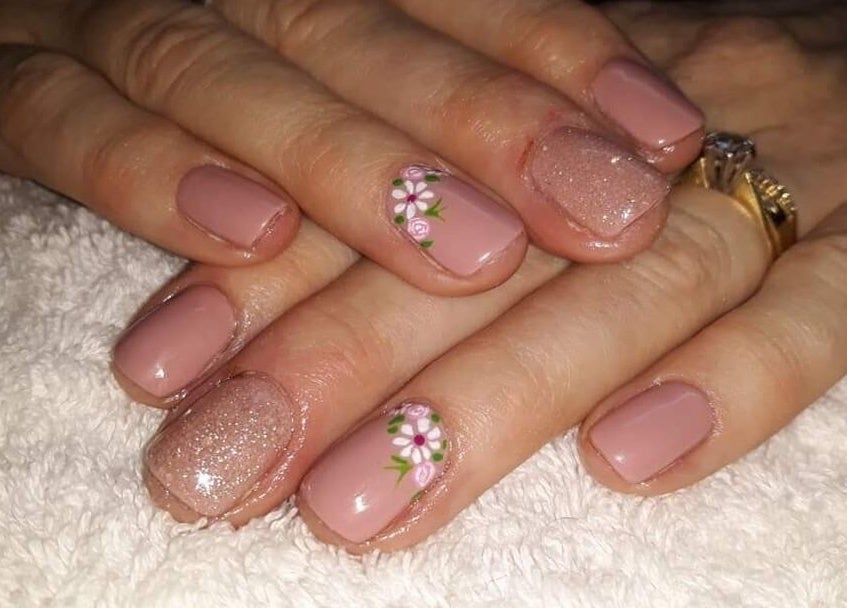 Stylish floral nail art on manicured nails at Janine Minnaar, Bothaville, Free State, ZA.