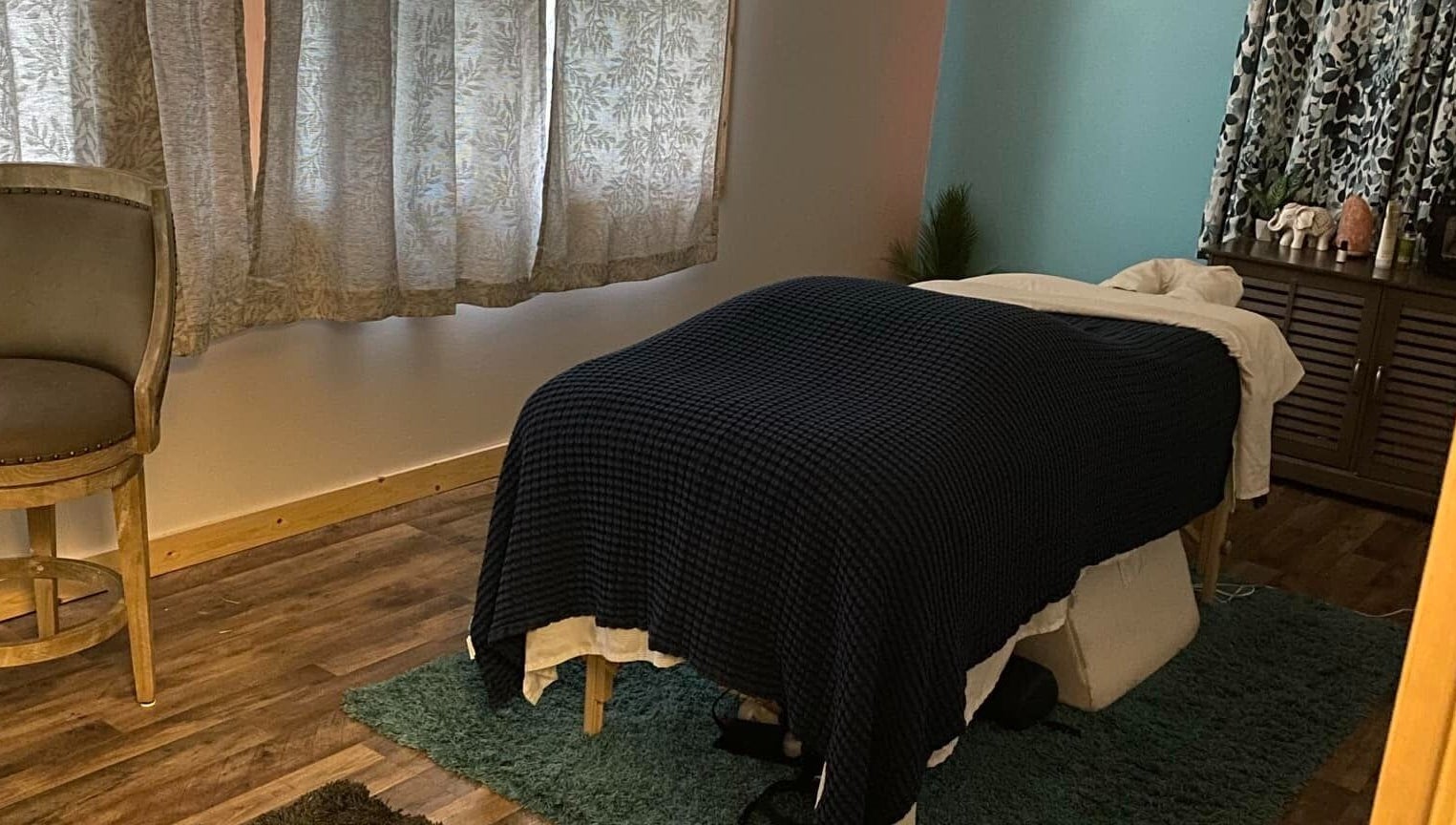 Cozy massage room at Sheboygan Wellness Studio, Sheboygan, Wisconsin, US, featuring ambient lighting and comfortable decor.