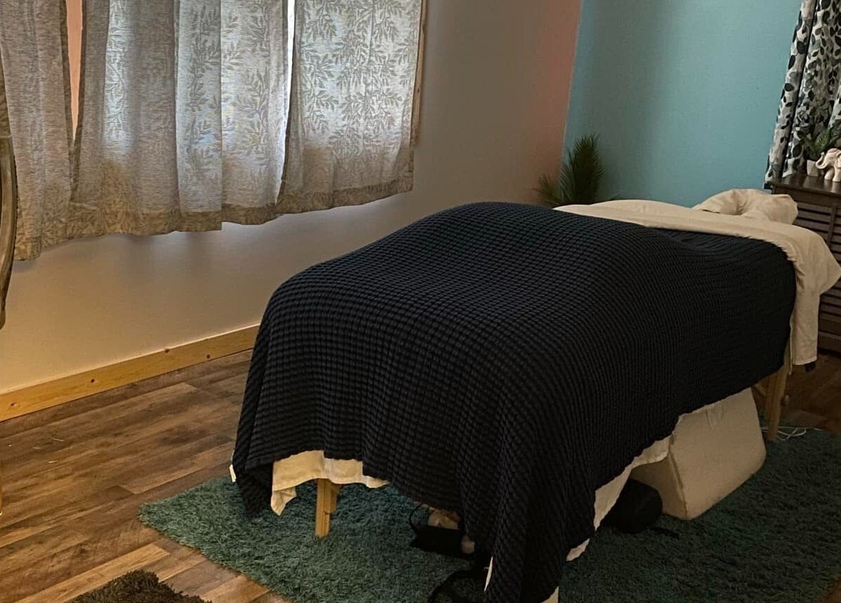 Cozy massage room at Sheboygan Wellness Studio, Sheboygan, Wisconsin, US, featuring ambient lighting and comfortable decor.
