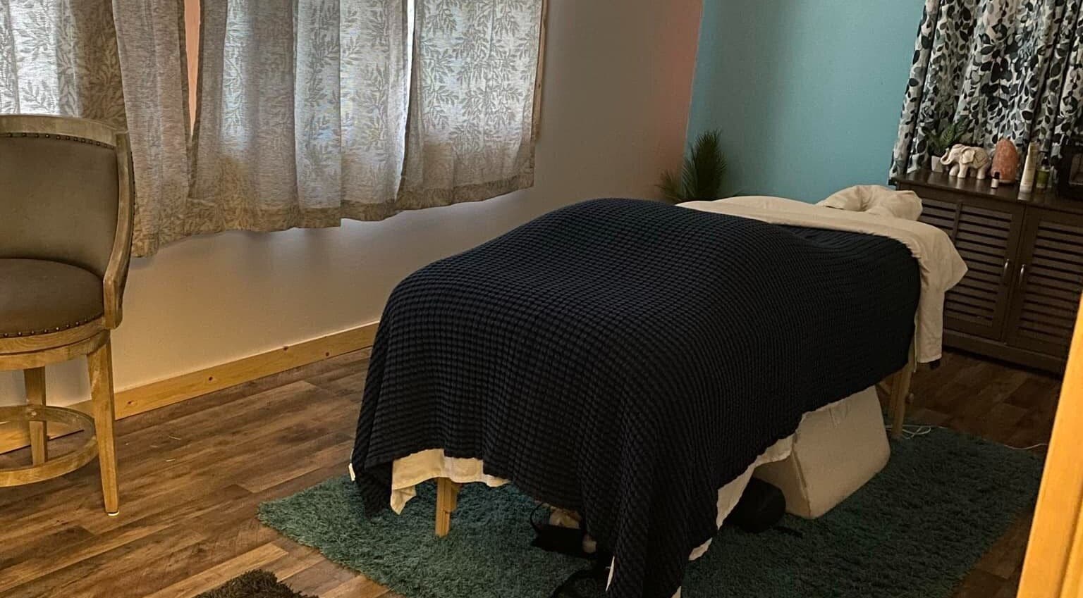 Cozy massage room at Sheboygan Wellness Studio, Sheboygan, Wisconsin, US, featuring ambient lighting and comfortable decor.