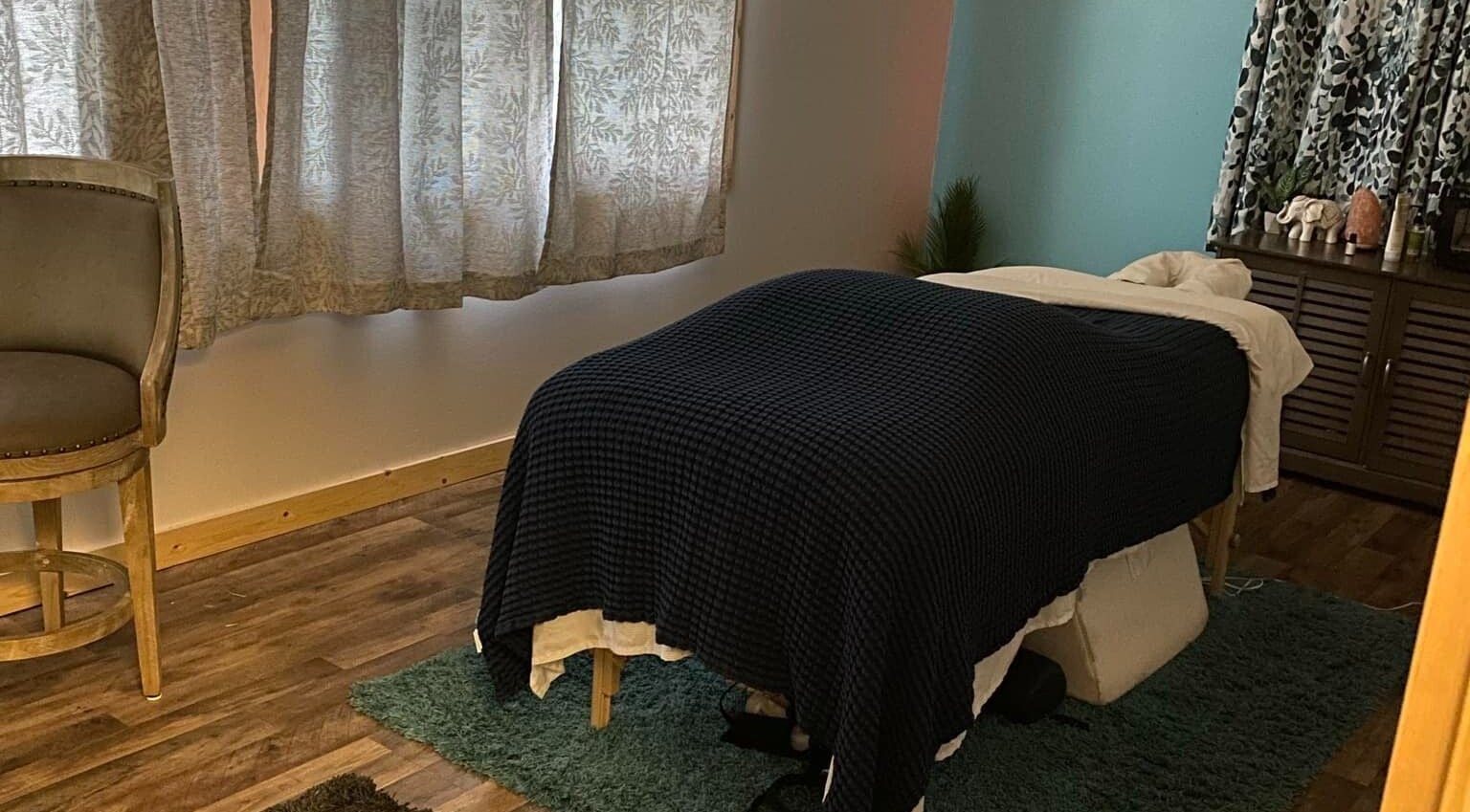 Cozy massage room at Sheboygan Wellness Studio, Sheboygan, Wisconsin, US, featuring ambient lighting and comfortable decor.