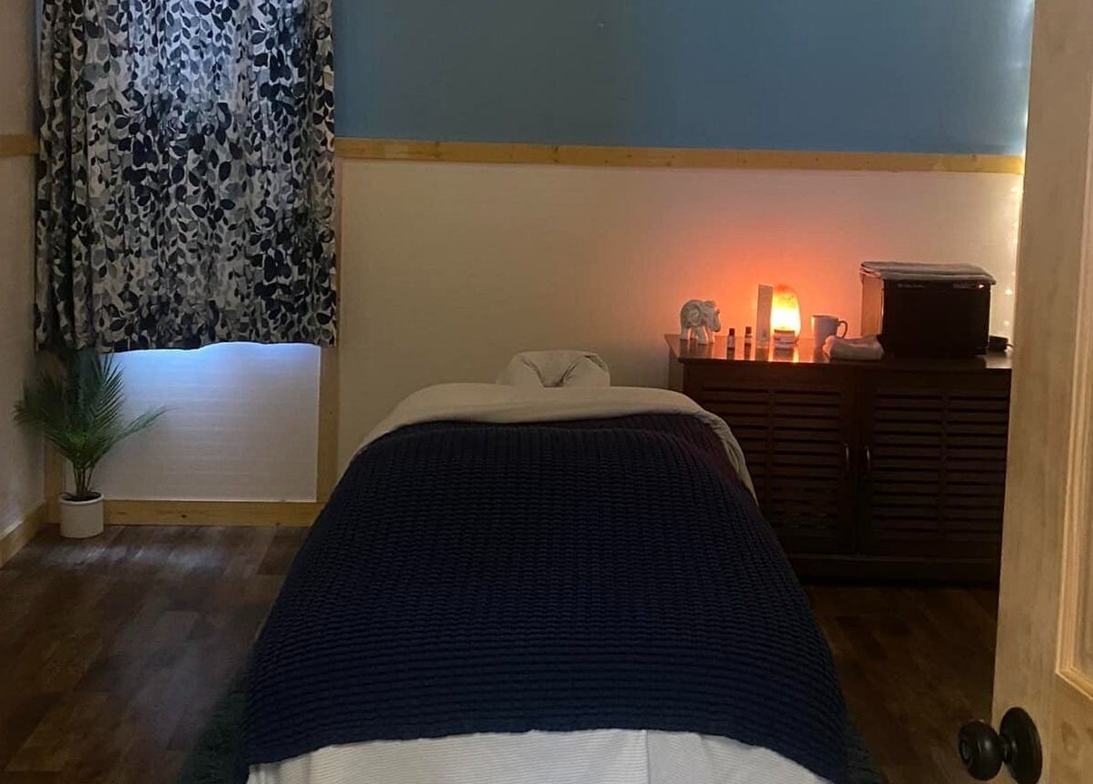 Serene massage room at Sheboygan Wellness Studio in Sheboygan, Wisconsin, US, featuring a cozy bed and warm lighting.
