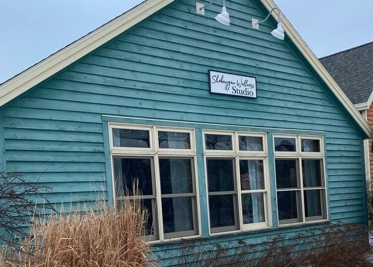 Exterior view of Sheboygan Wellness Studio, a serene blue building in Sheboygan, Wisconsin, US.