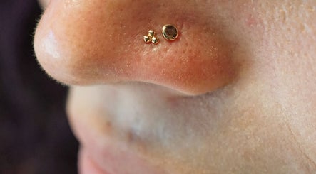 Gold nose studs at Vaughn Body Arts in Monterey, California, US enhance individual style and beauty.