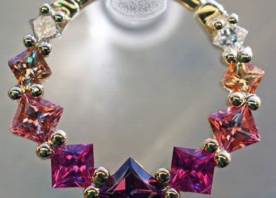 Colorful gemstone jewelry at Vaughn Body Arts in Monterey, California, US, showcasing intricate design.