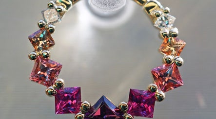 Colorful gemstone jewelry at Vaughn Body Arts in Monterey, California, US, showcasing intricate design.