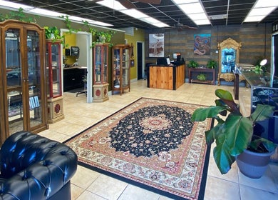 Stylish interior of Vaughn Body Arts in Monterey, California, US with elegant furniture and vibrant plants.