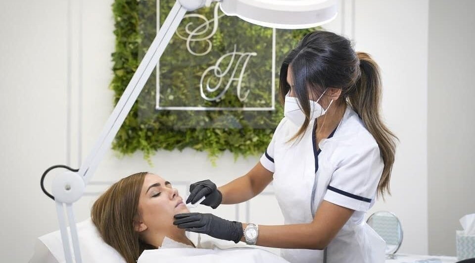 Expert aesthetician providing facial treatment at Snobs Aesthetics, Telford, England, GB.