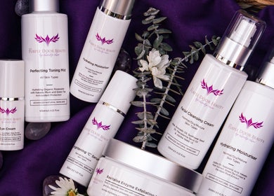 Purple Door Beauty skincare products on purple fabric, South Maclean, Queensland, AU.