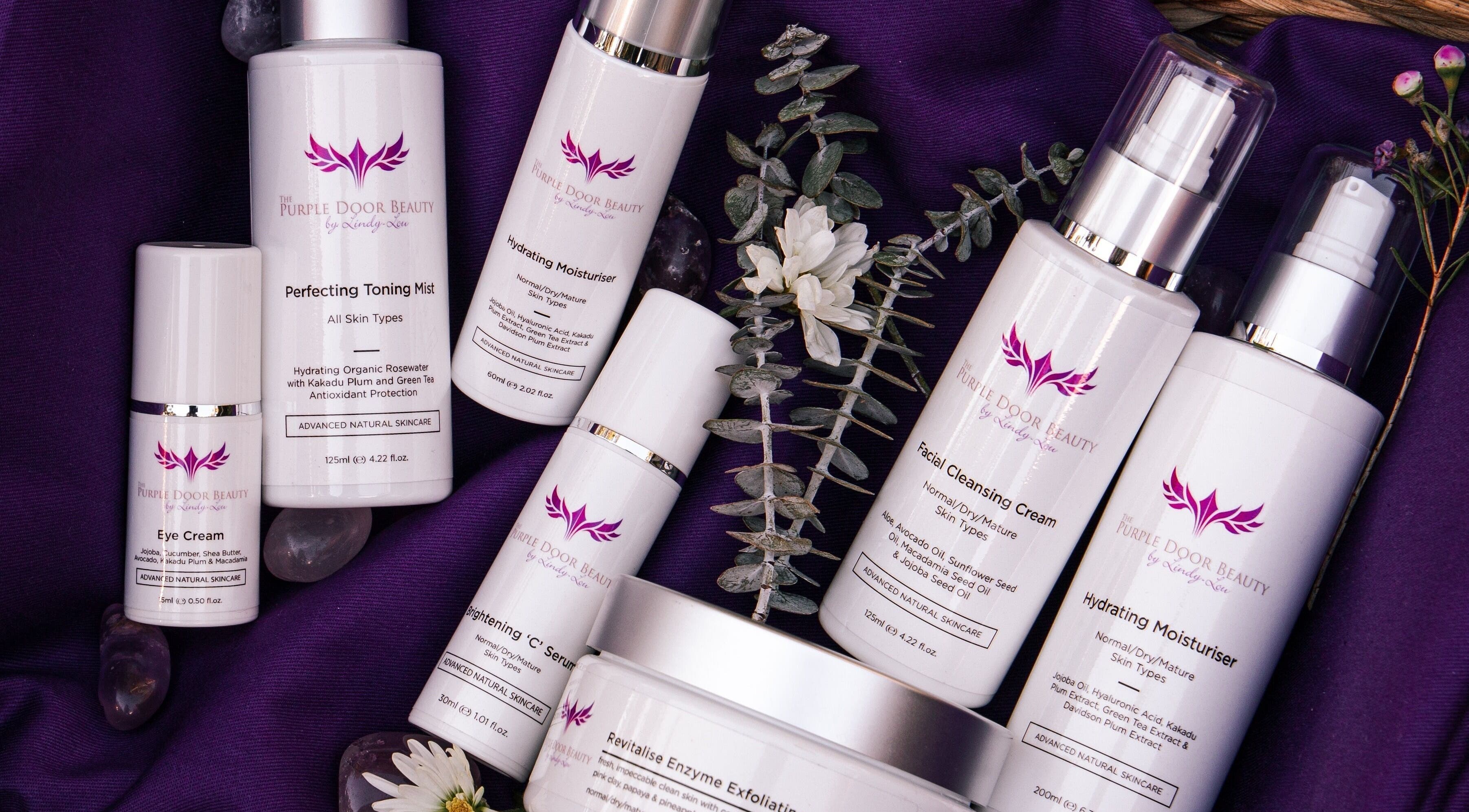 Purple Door Beauty skincare collection on purple fabric, South Maclean, Queensland, AU.