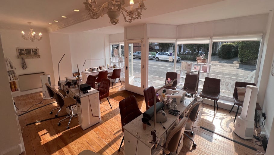 Cozy interior of TLC Beauty Studio in Chichester, England, GB with elegant chairs and wooden floors.