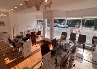 Cozy interior of TLC Beauty Studio in Chichester, England, GB with elegant chairs and wooden floors.
