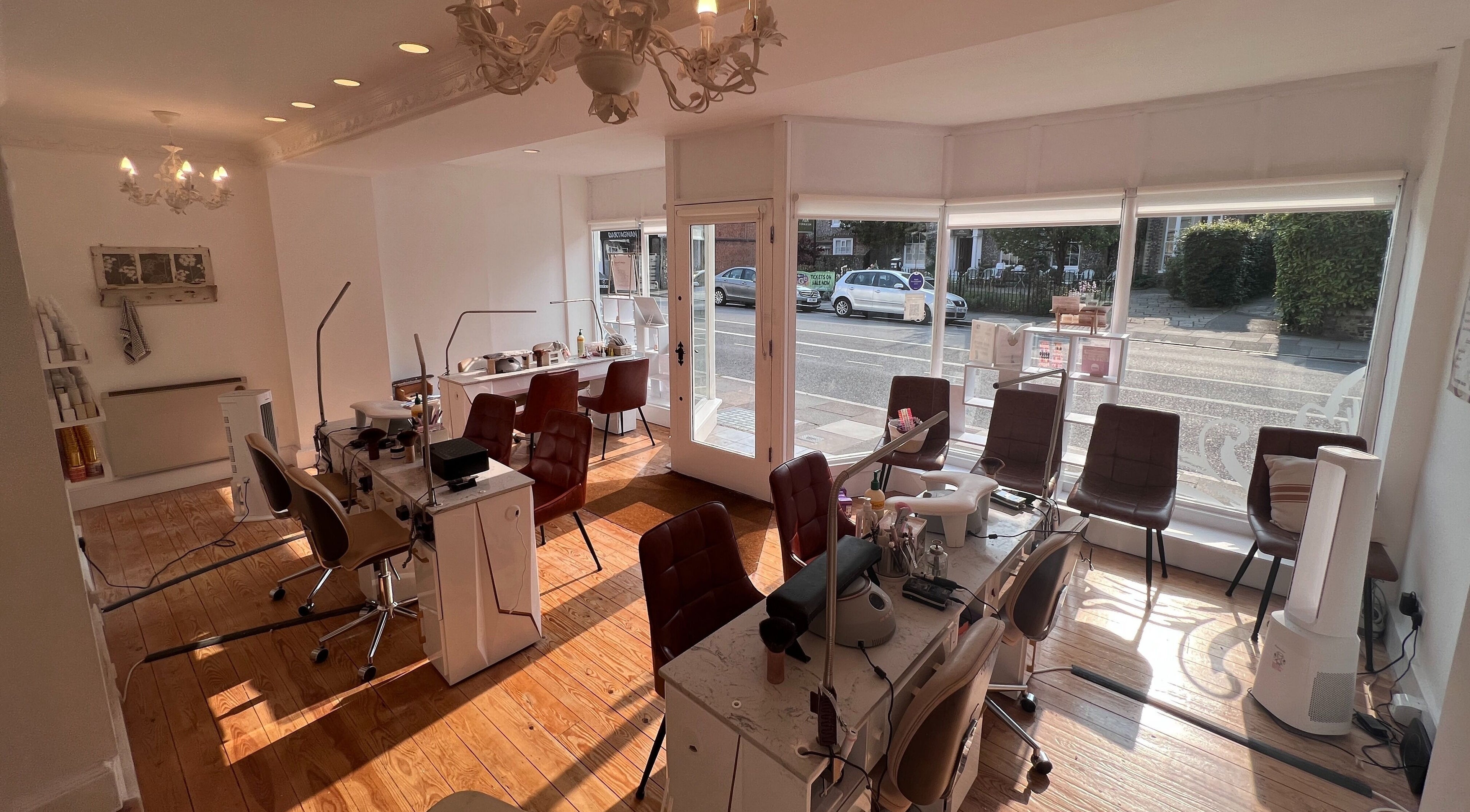 Cozy interior of TLC Beauty Studio in Chichester, England, GB with elegant chairs and wooden floors.