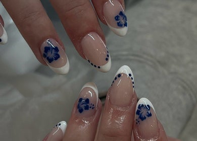 Elegant nail art with blue floral design at TLC Beauty Studio, Chichester, England, GB.
