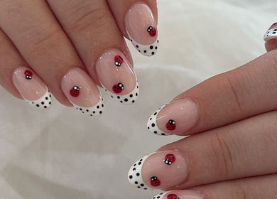 Stylish ladybug nail art at TLC Beauty Studio, Chichester, England, GB. Perfect blend of creative and chic designs.