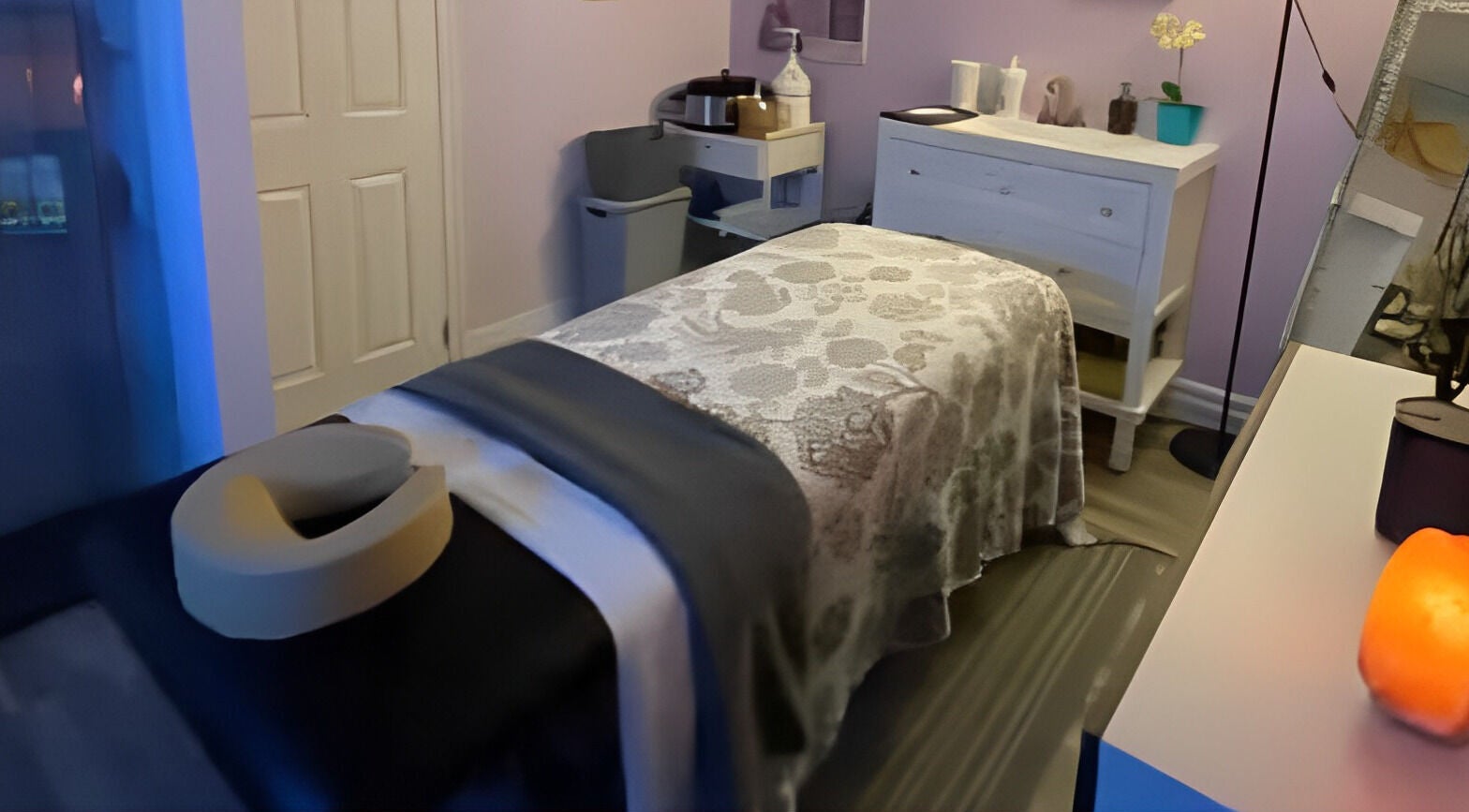 Relaxing treatment room at HOLY HAIR, SKIN & HOMEOPATHY in Brantford, Ontario, CA, featuring a cozy massage table.
