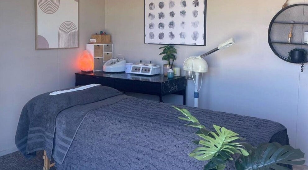 The Littlest Beauty Studio's serene treatment space in Auckland, Auckland, NZ, featuring a massage bed and calming decor.