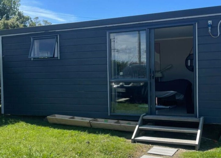 Exterior view of The Littlest Beauty Studio, a modern gray building in Auckland, Auckland, NZ.