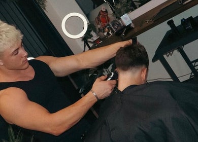Barber at Studio 61 Barbershop in Long Jetty, New South Wales, AU giving a stylish haircut to a client.