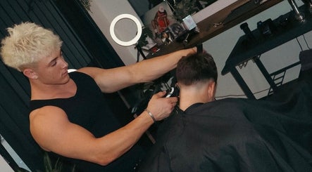 Barber at Studio 61 Barbershop in Long Jetty, New South Wales, AU giving a stylish haircut to a client.