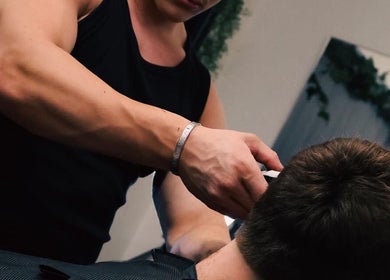 Barber performing haircut at Studio 61 Barbershop in Long Jetty, New South Wales, AU.