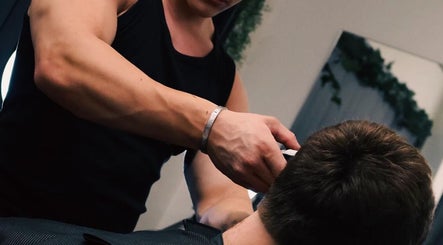 Barber performing haircut at Studio 61 Barbershop in Long Jetty, New South Wales, AU.