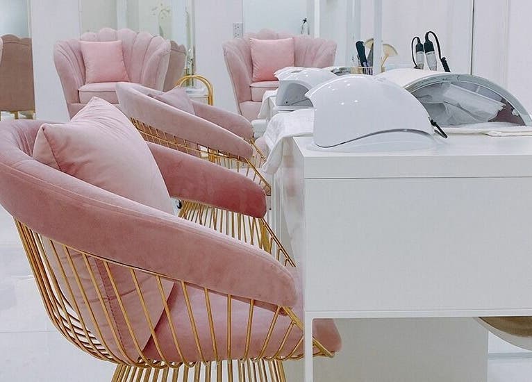Intérieur chic de Joséphine Nails Dubai avec fauteuils roses et équipements modernes à Dubai, Dubai, AE.