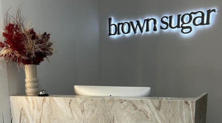 Reception desk with floral decor at Brown Sugar Rozelle, Rozelle, New South Wales, AU.