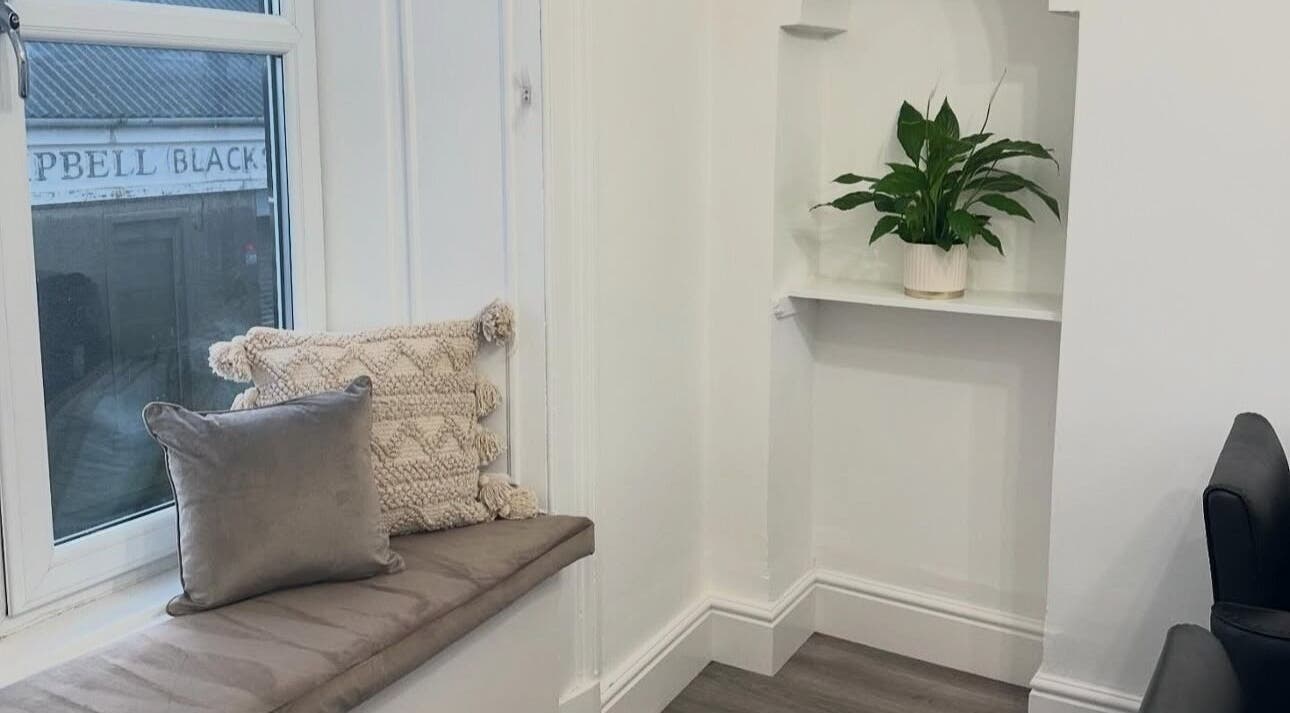 Inviting seating area with cushions at Hair I Am by Hazel Watson, Hamilton, Scotland, GB.