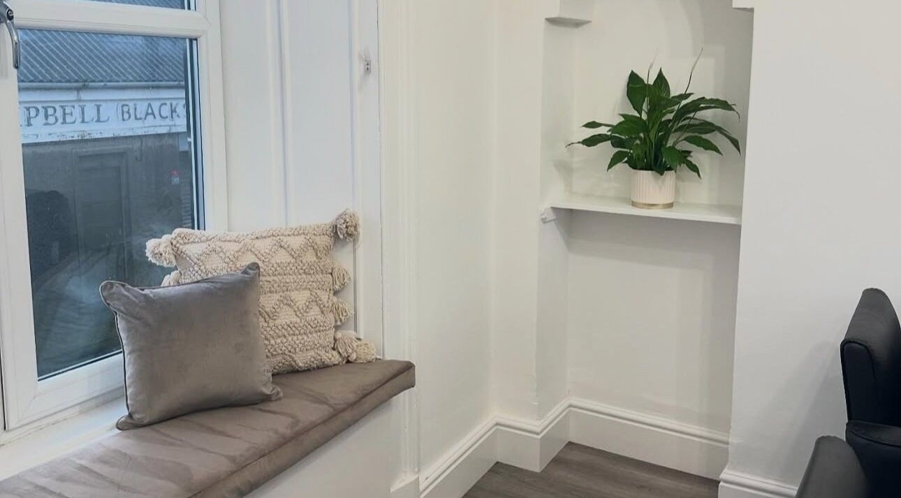 Inviting seating area with cushions at Hair I Am by Hazel Watson, Hamilton, Scotland, GB.