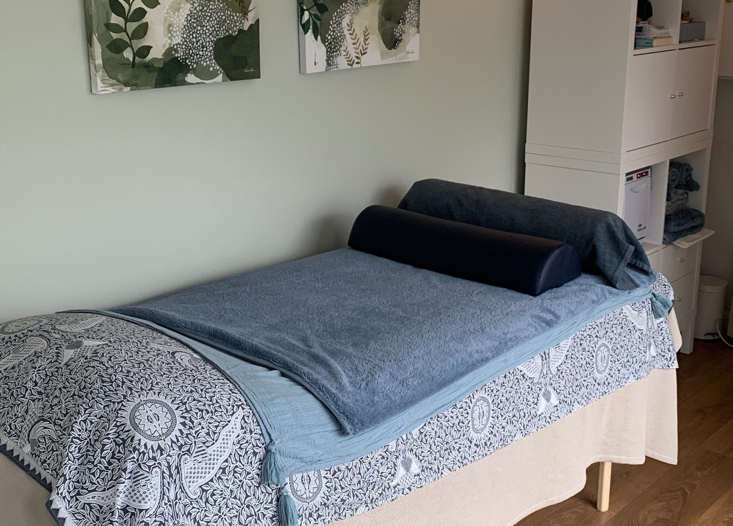 Calm therapy room at Tonic Reflexology, Derby, England, GB with a massage bed and soothing decor.