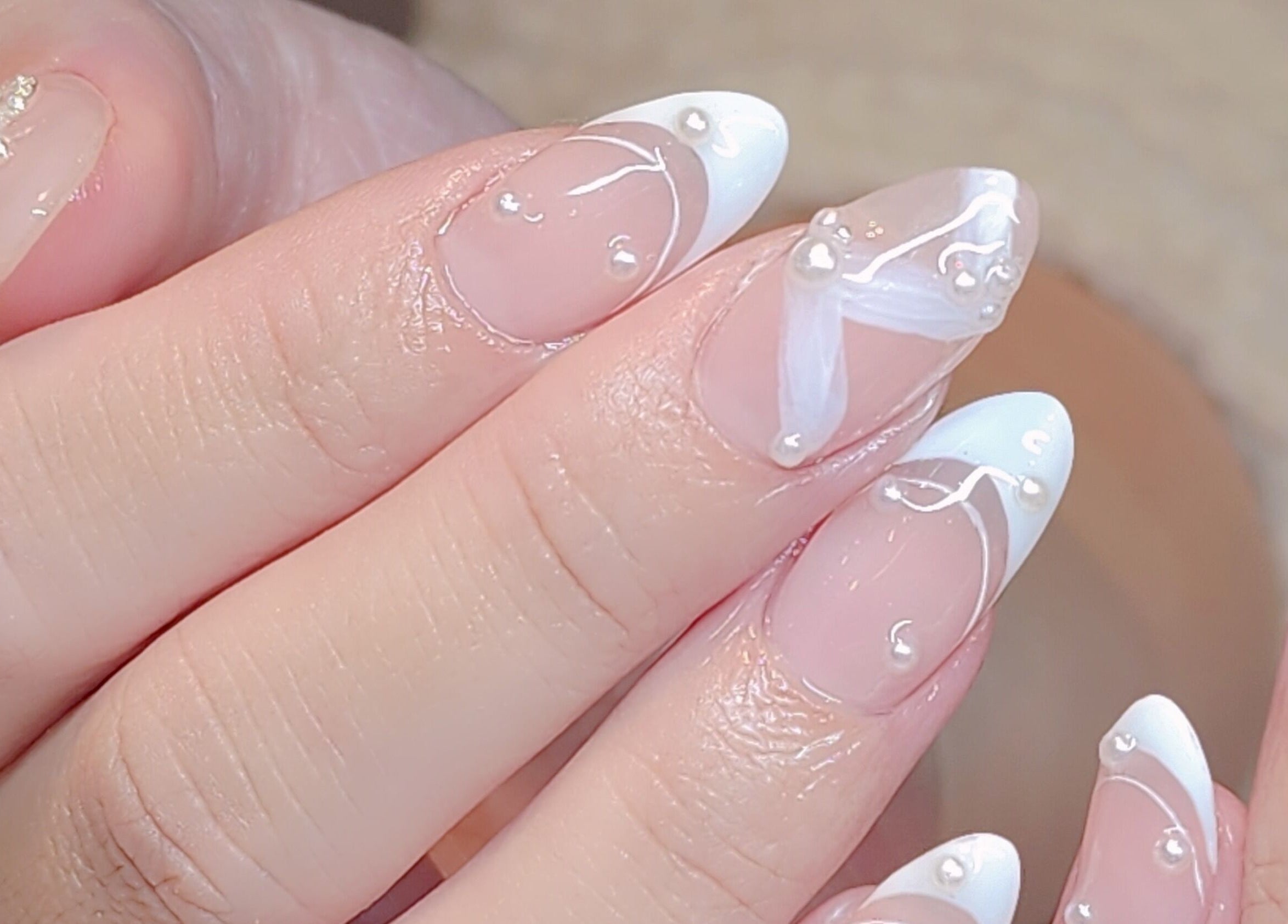 Intricate white pearl nail art at Wonderbu Nails in Melbourne, Victoria, AU showcasing elegant design.