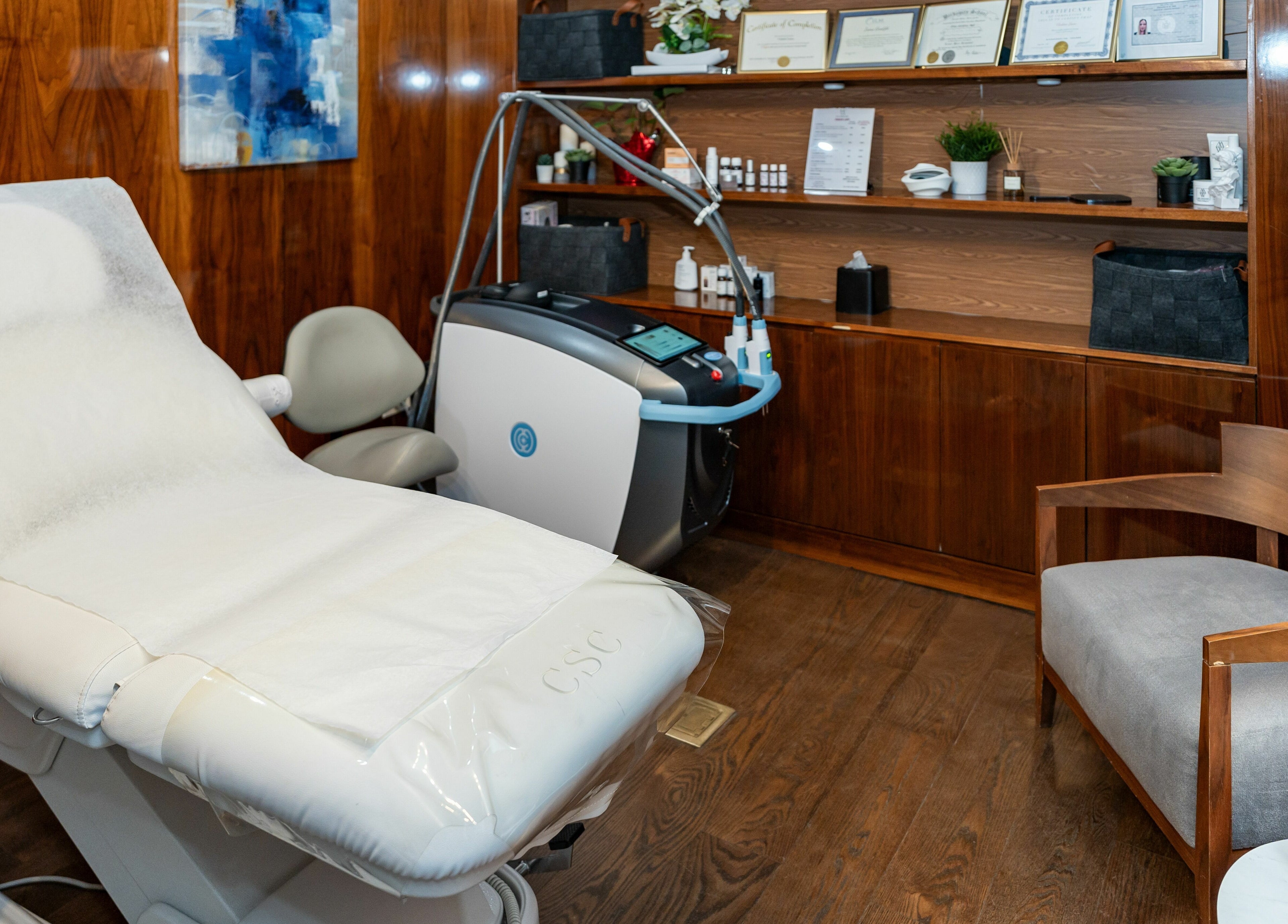 Relaxing treatment room at W Laser Inc, New York, New York, US, featuring a comfortable chair and modern equipment.