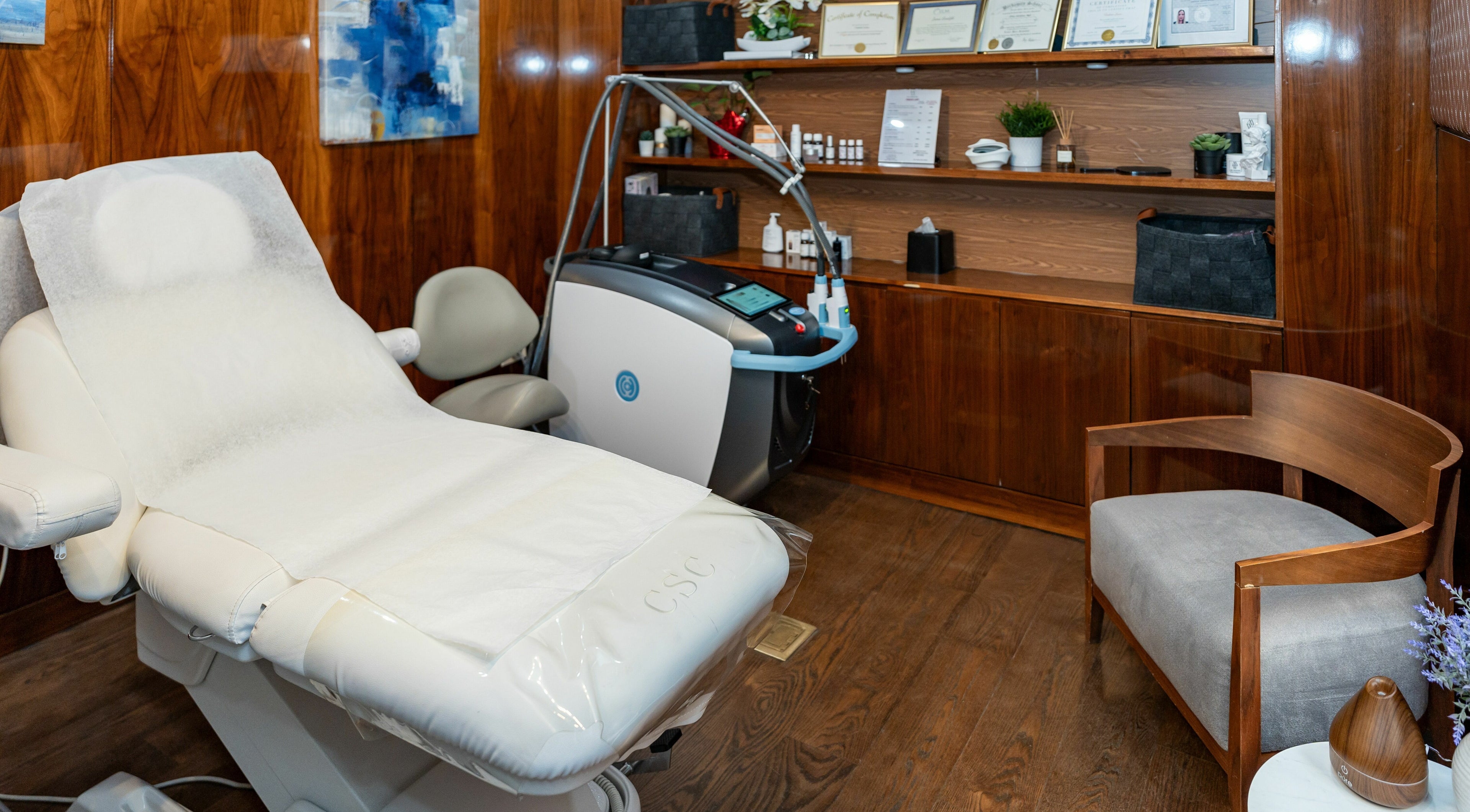 Relaxing treatment room at W Laser Inc, New York, New York, US, featuring a comfortable chair and modern equipment.