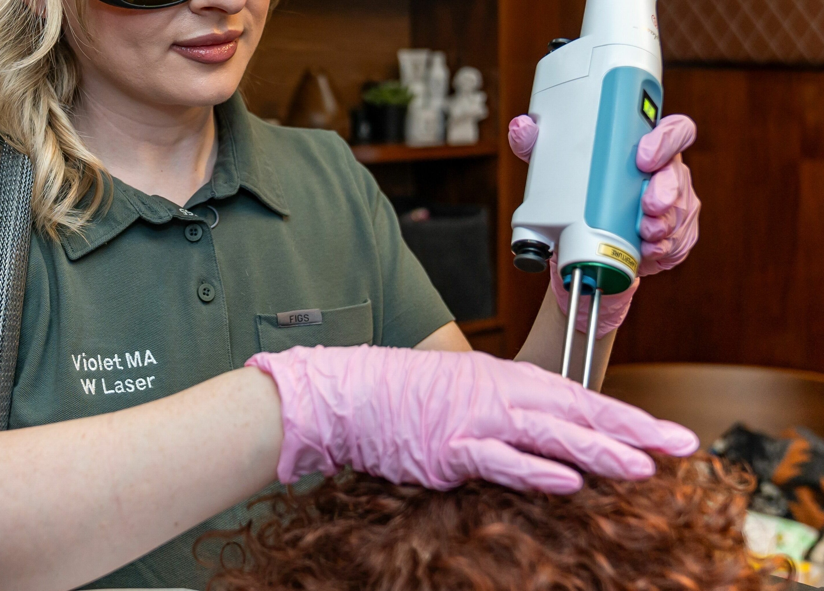 Laser treatment at W Laser Inc, New York, New York, US by professional in protective gear.