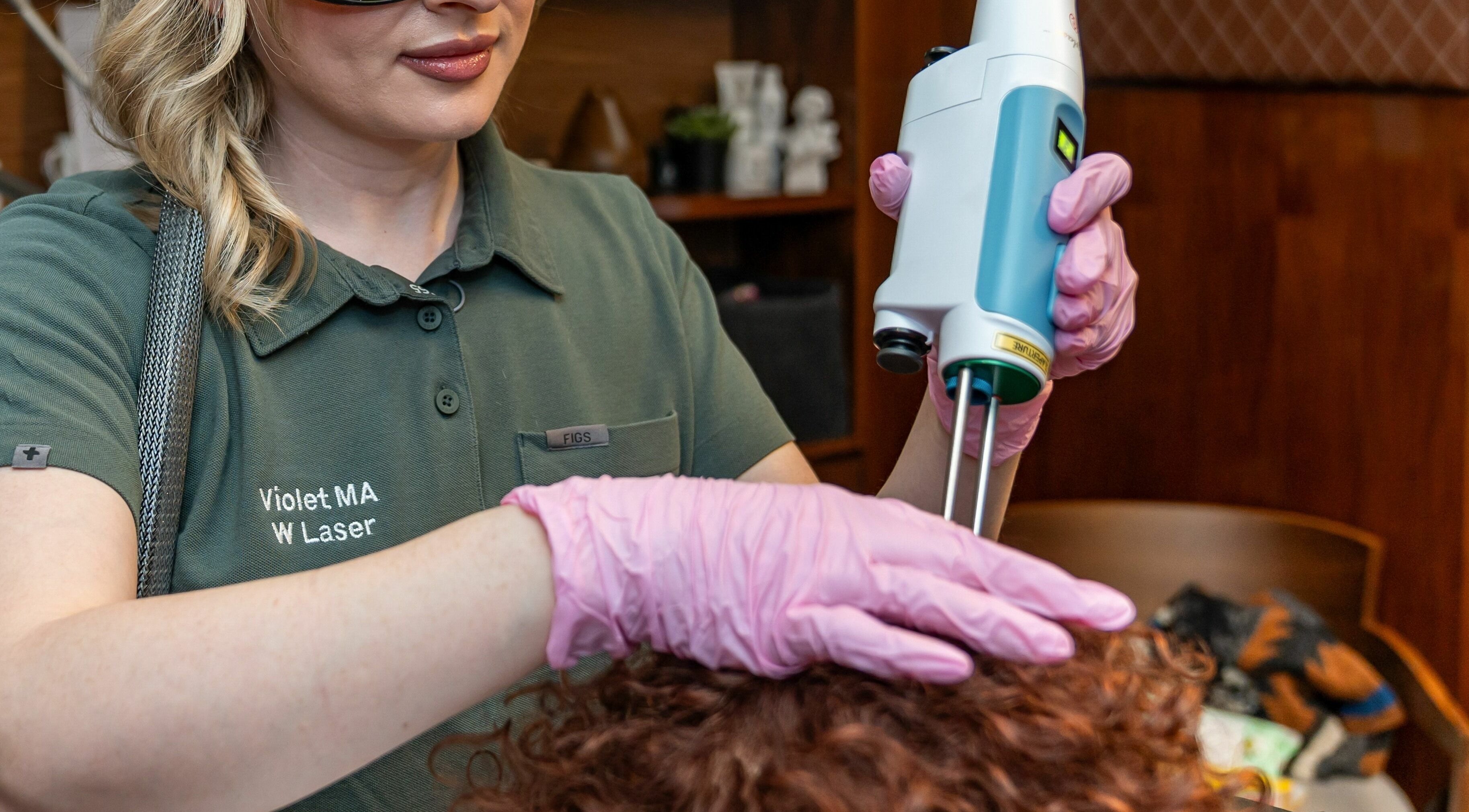 Laser treatment at W Laser Inc, New York, New York, US by professional in protective gear.