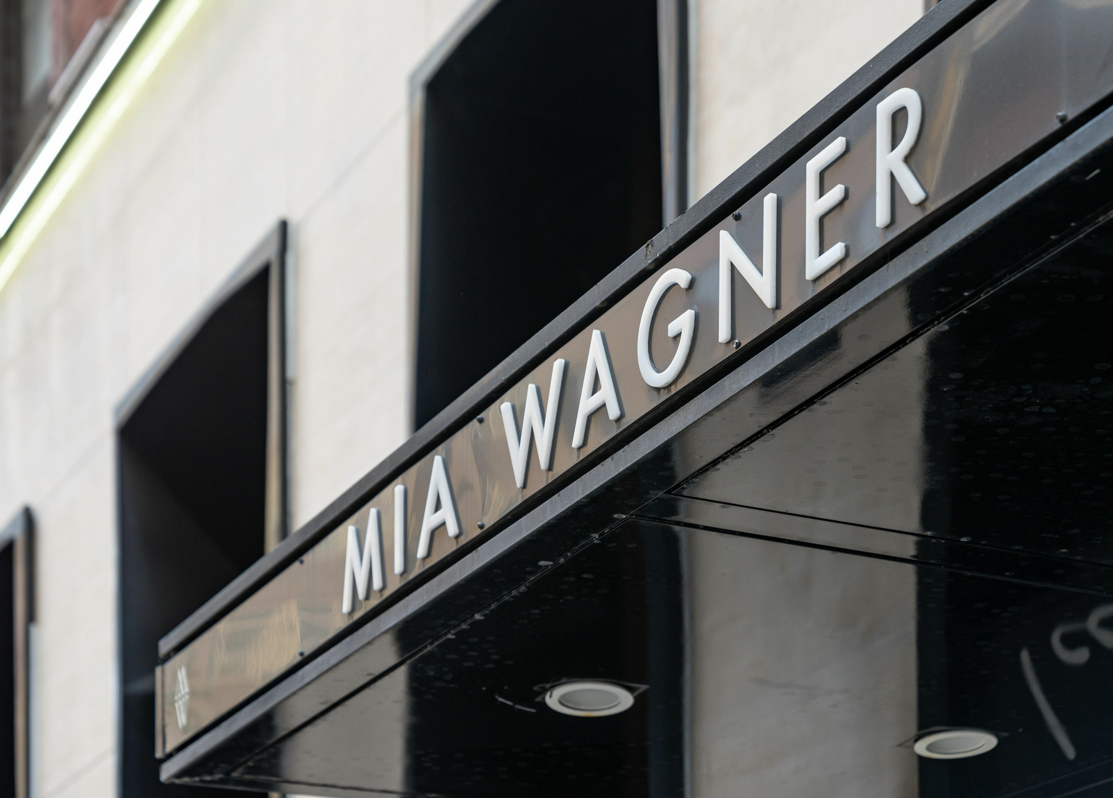 Sleek signage of W Laser Inc at New York, New York, US building entrance.