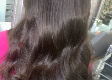Glossy brunette waves styled at Hair by Emma, Motherwell, Scotland, GB salon with reflections in mirror.