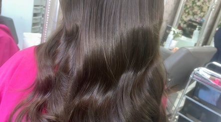 Glossy brunette waves styled at Hair by Emma, Motherwell, Scotland, GB salon with reflections in mirror.