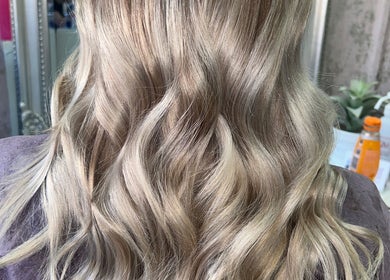 Blonde wavy hair styled at Hair by Emma in Motherwell, Scotland, GB. Elegant salon look for modern styles.